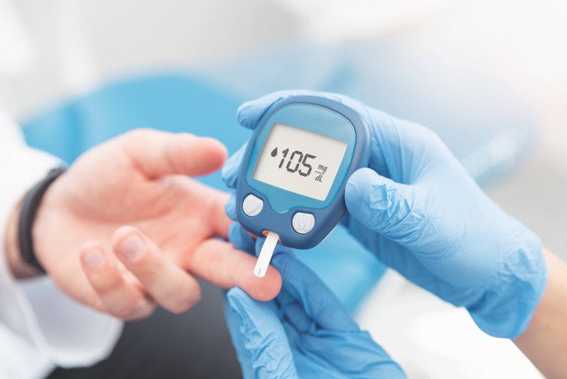 A doctor checking a patient’s blood sugar levels